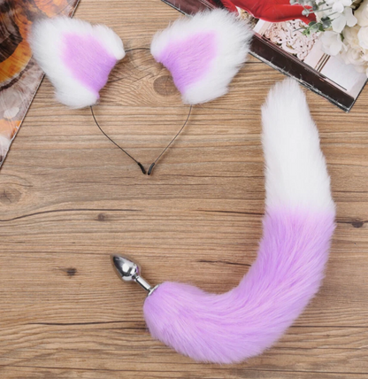 Pink fox tail with white tips on a wooden surface