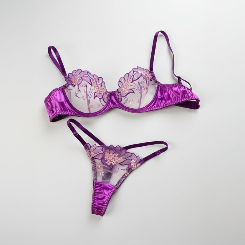 Purple floral lingerie set on a light gray background