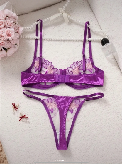 Purple lingerie set with floral design on a white surface.