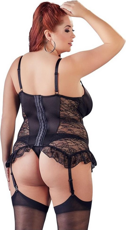 Woman wearing a black lace lingerie set on a white background