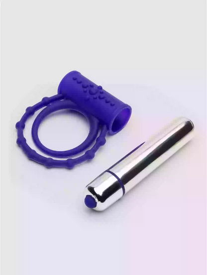 Purple silicone ring and silver cylindrical object on a white background
