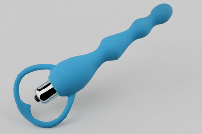 Blue silicone ring with metallic end on a gray background