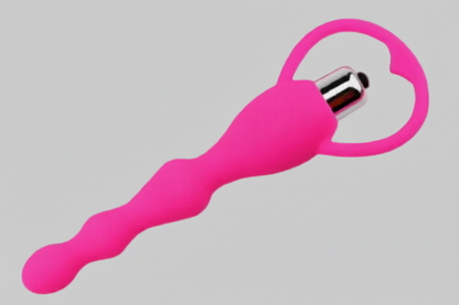 Pink silicone tool with a metallic end on a gray background