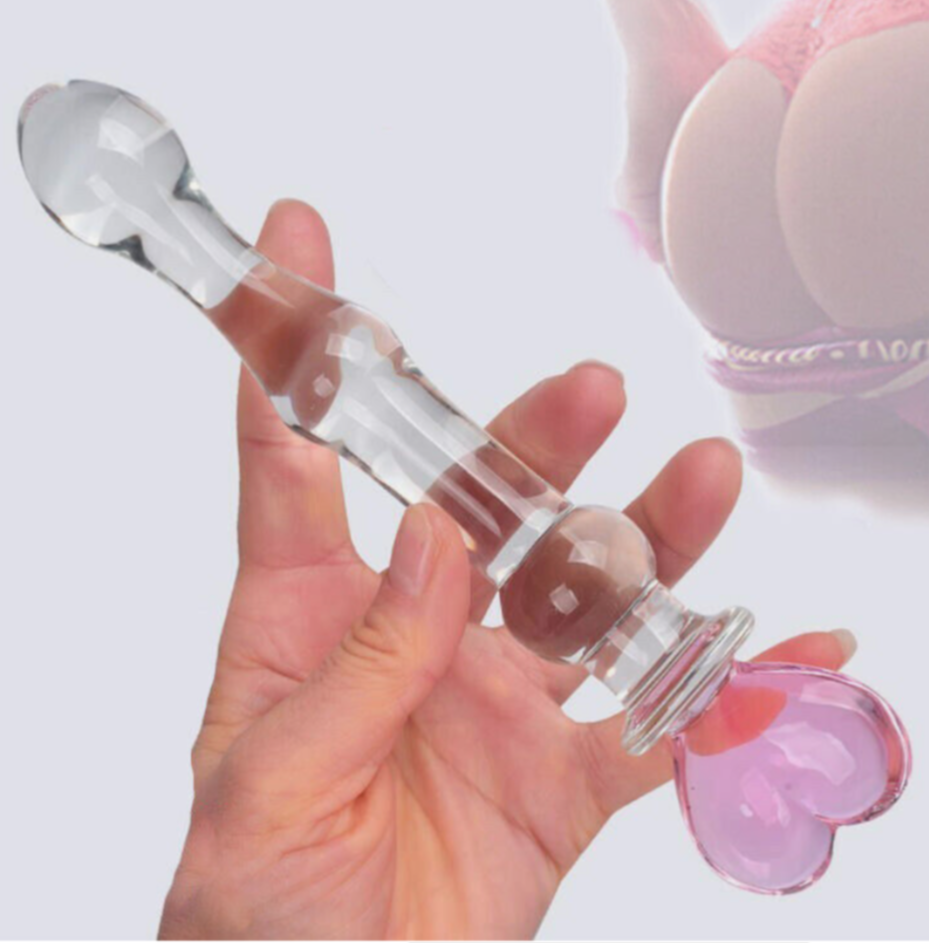 Clear glass smoking accessory with pink and white accents held in a hand against a light background.