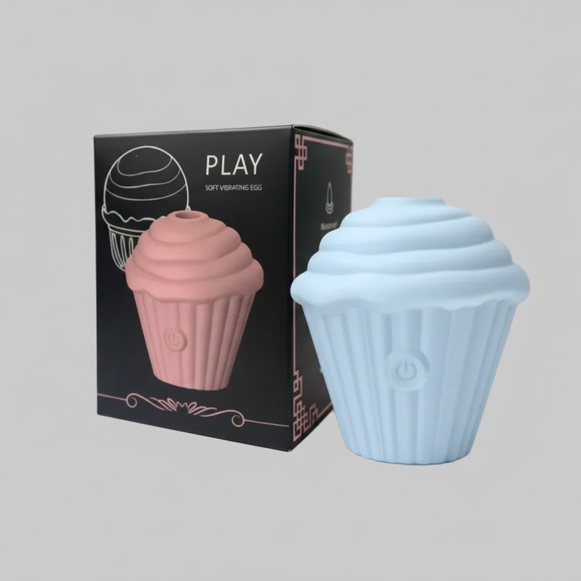 Cupcake-shaped product with pink and blue colors next to its packaging on a gray background