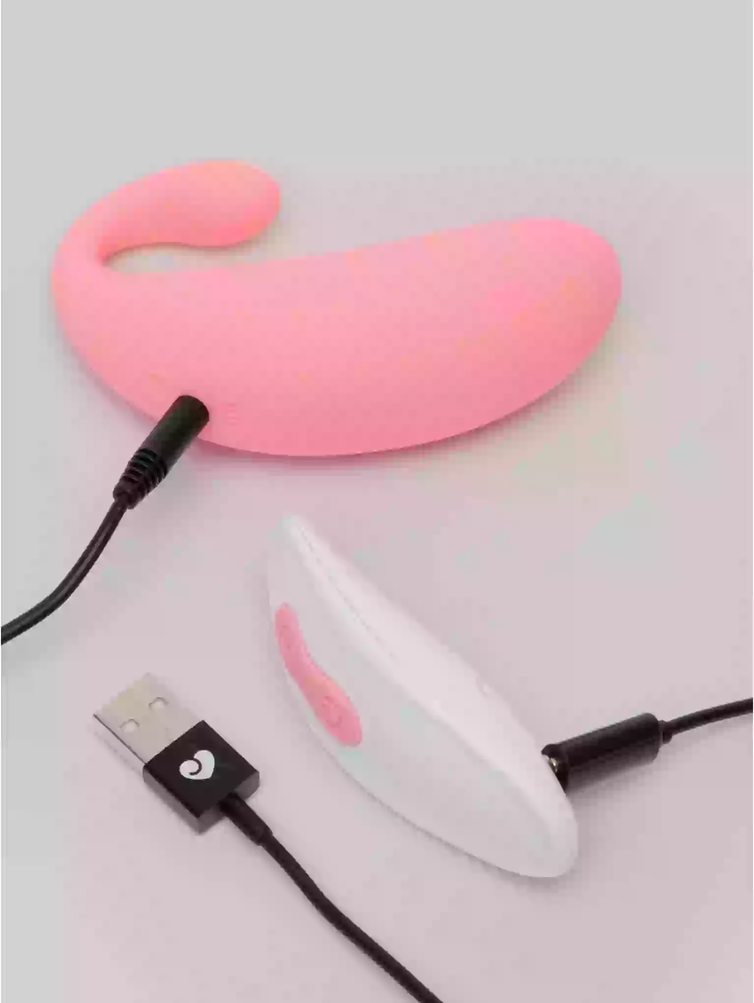 Pink and white silicone product with USB cable on a light gray background