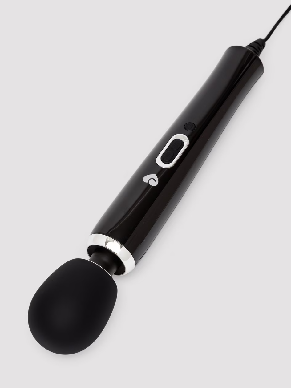 Black handheld device with a spoon-like end on a light gray background
