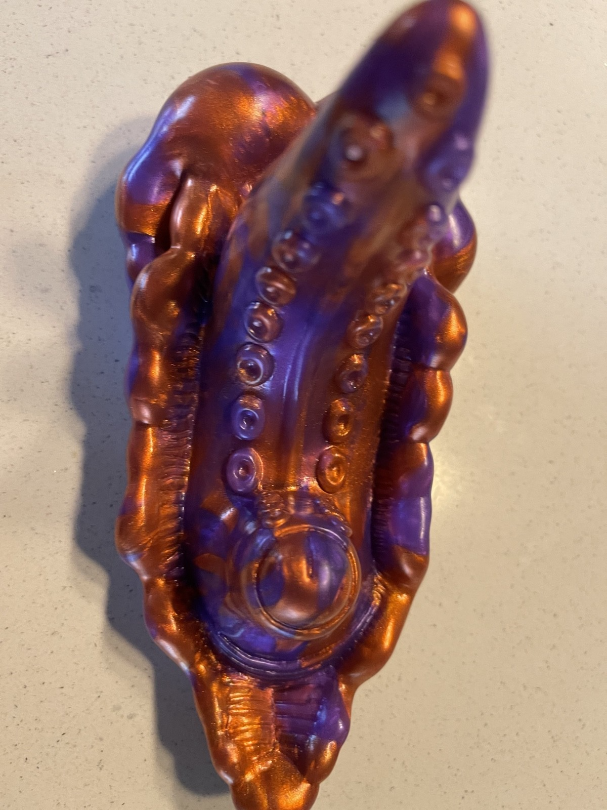 Decorative handle with intricate design on a beige background