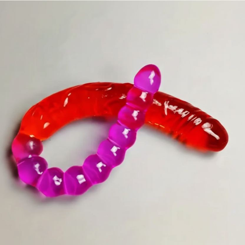 Pink and red gelatinous worm-like object on a light gray background