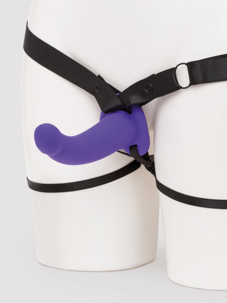 Black harness with a purple component on a white background