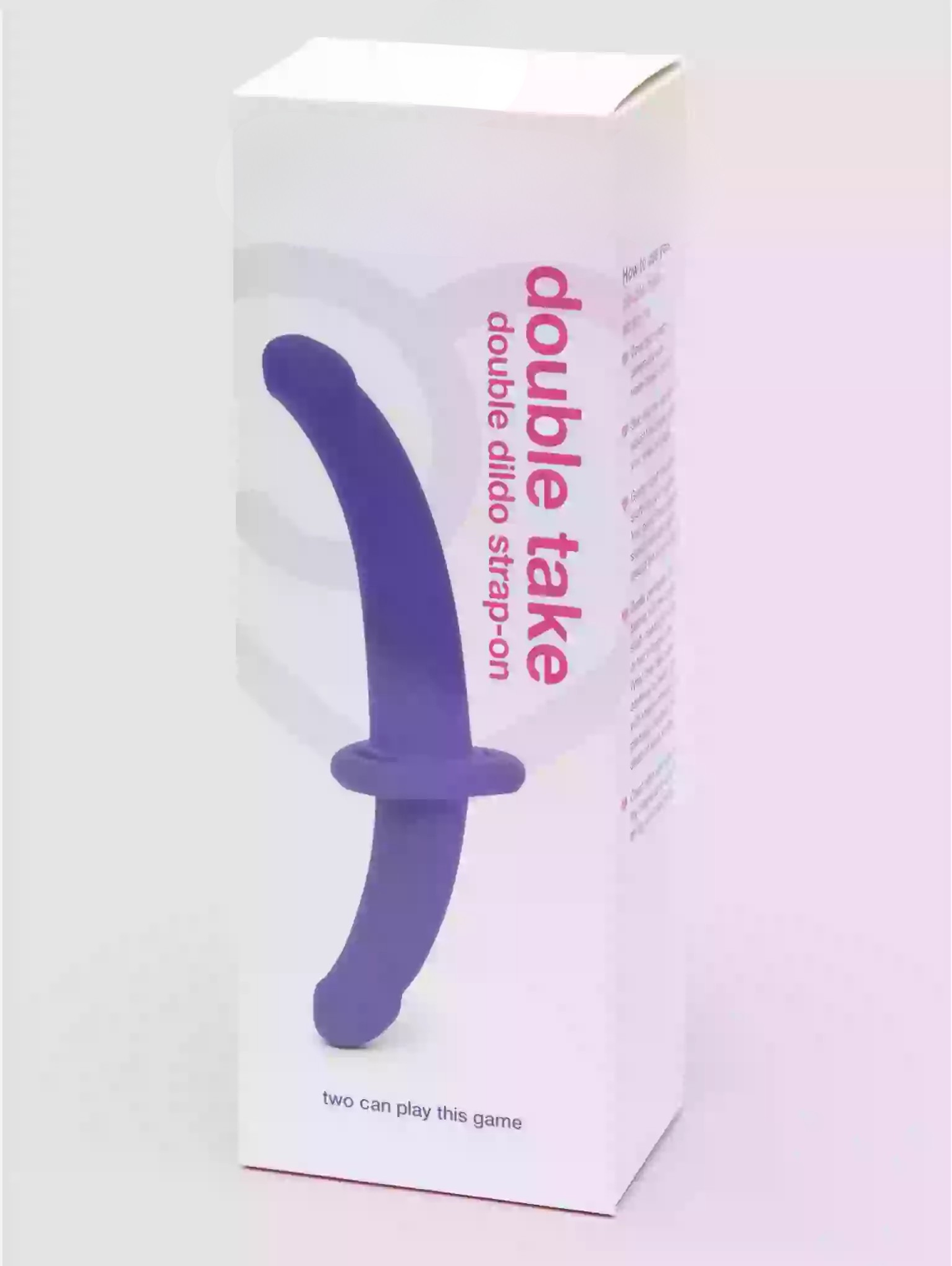 Box of a 'double take' product with a purple strap-on on a white background