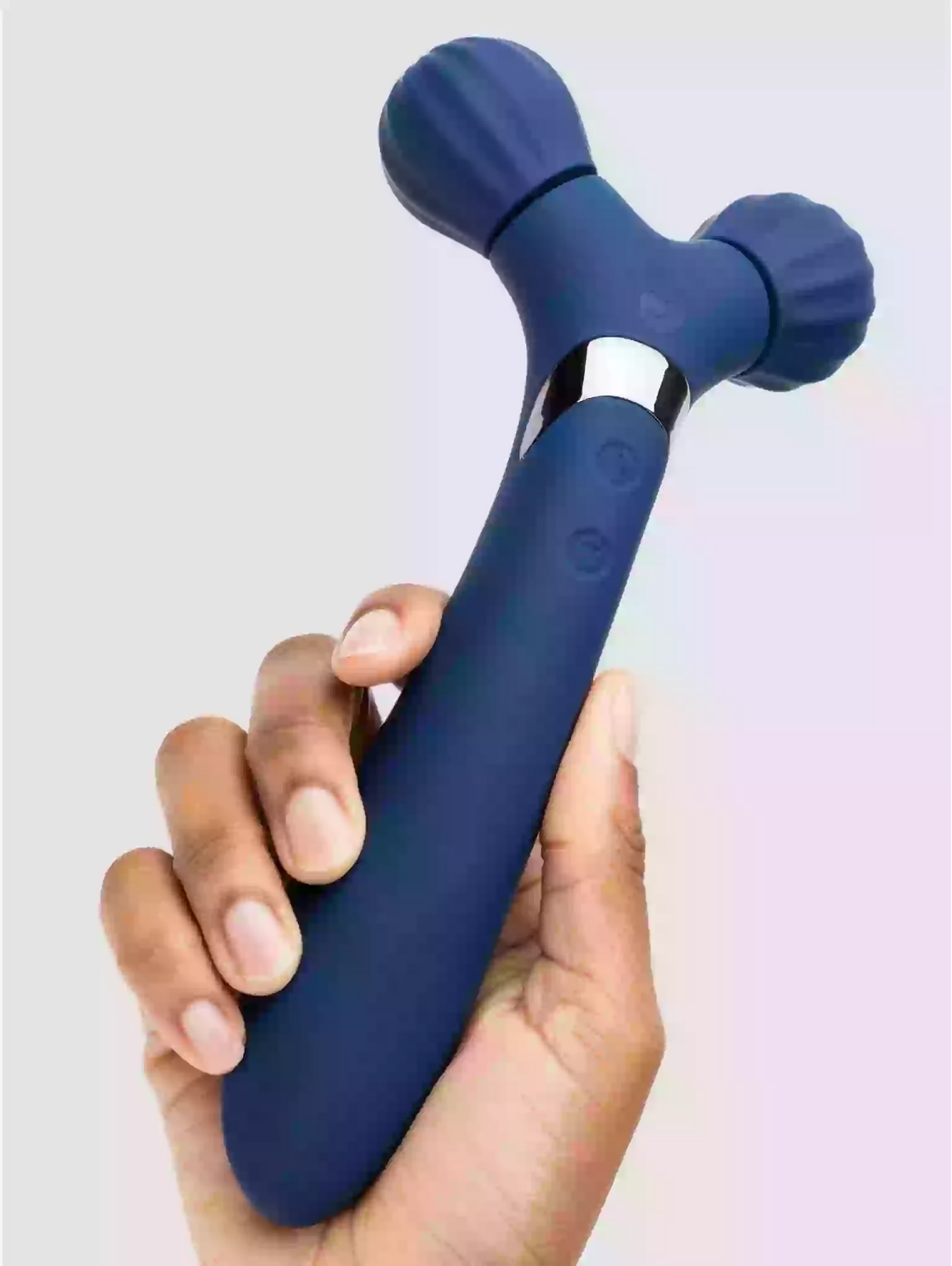 Blue handheld massager held in a hand against a light background
