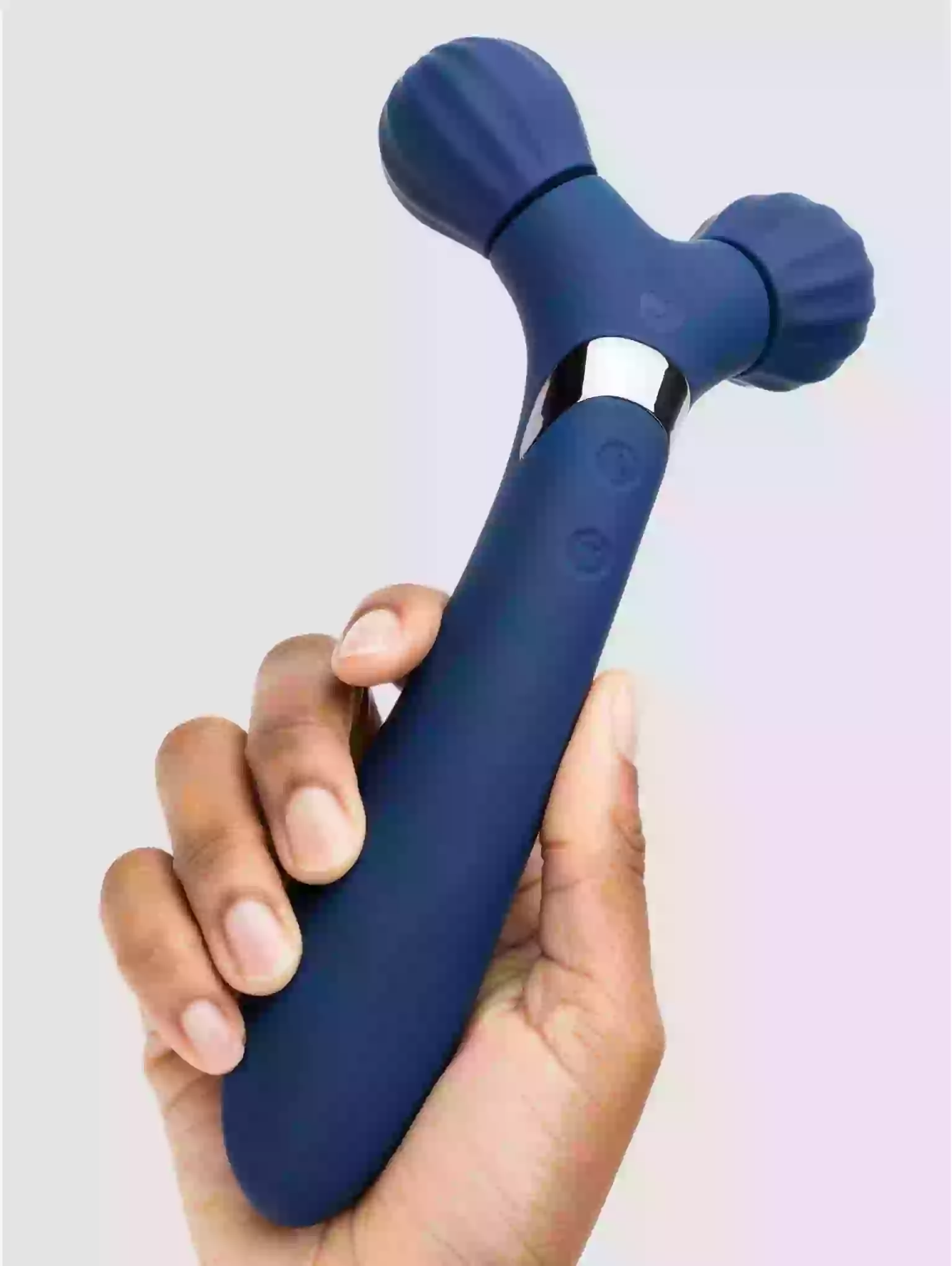Blue handheld massager held in a hand against a light background