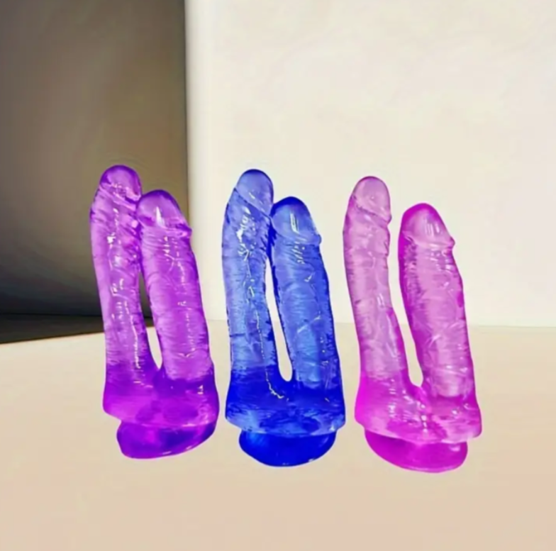 Two pairs of purple and blue silicone condoms on a beige surface.