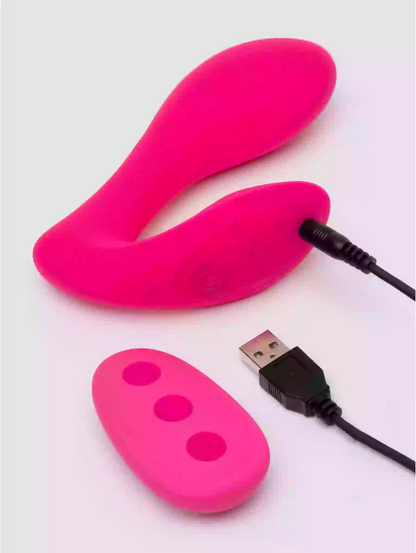 Pink electronic device with USB cable on a white background