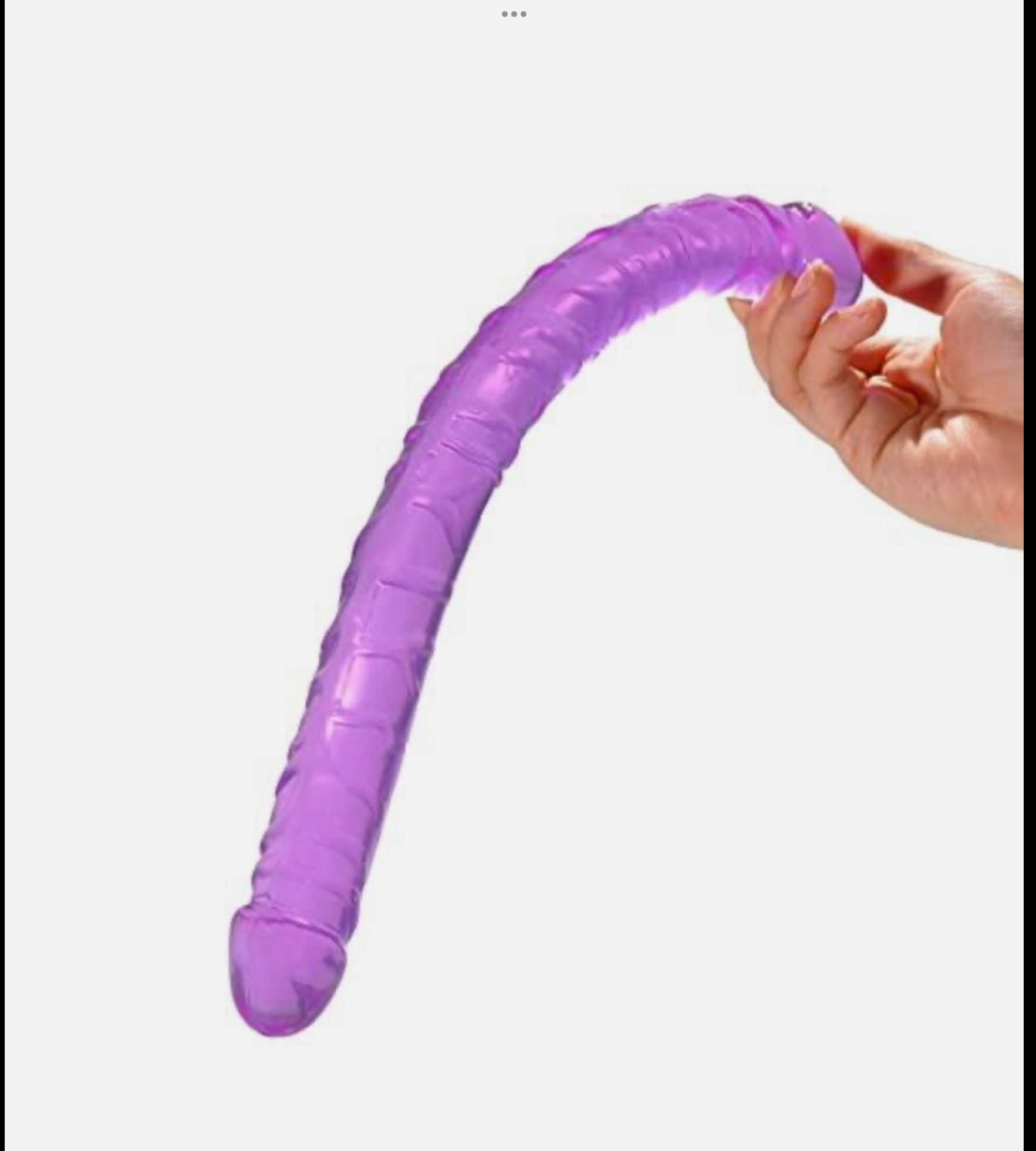 Purple flexible tube held by a hand on a white background