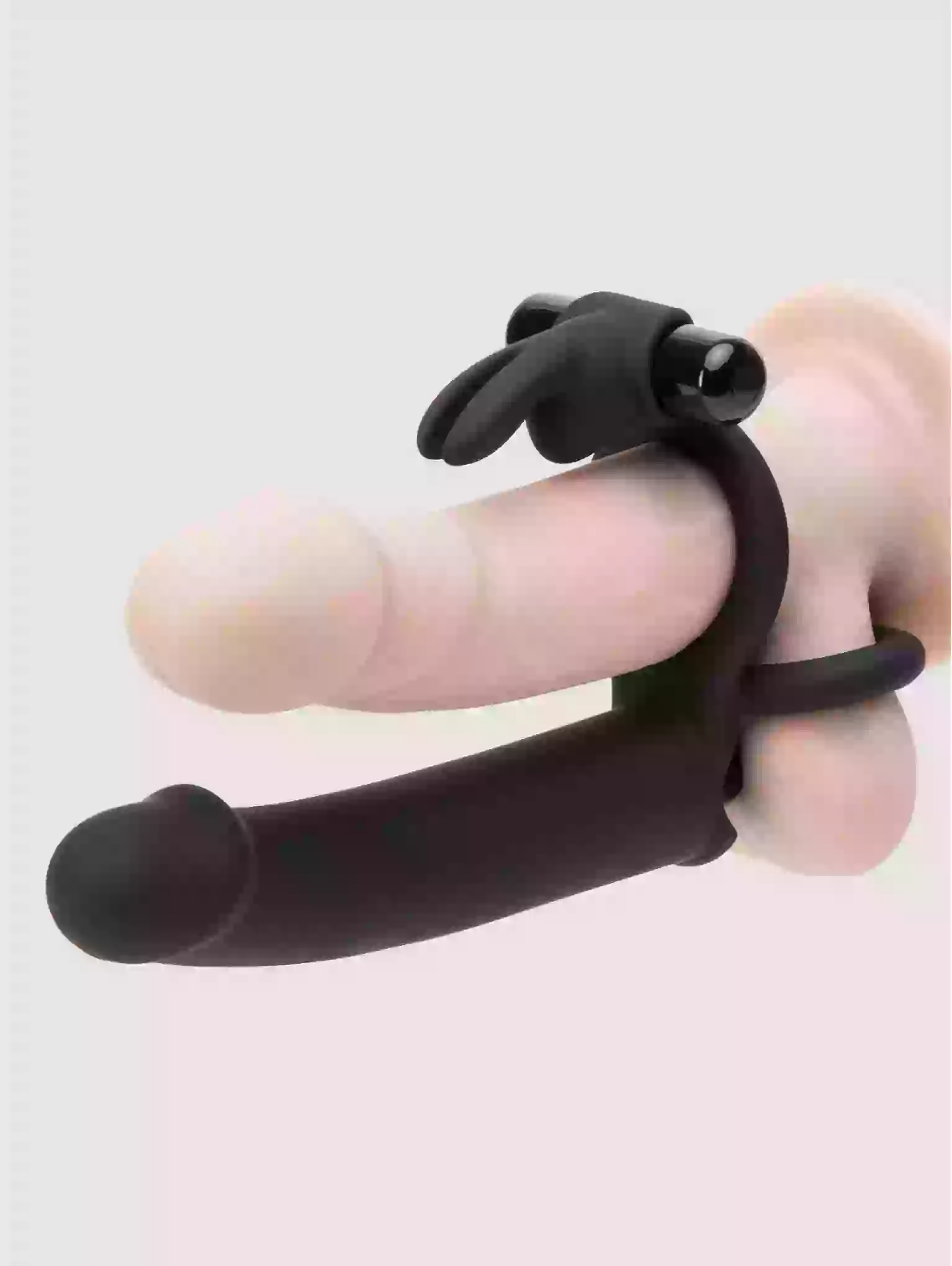 Black finger exerciser on a light pink background