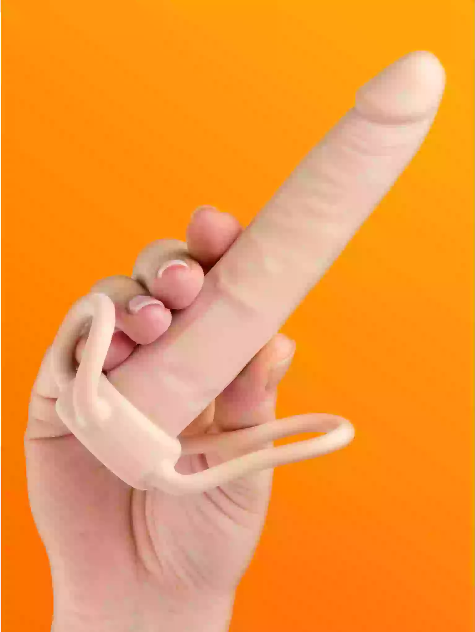Hand holding a silicone ring against an orange background