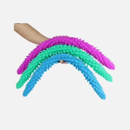 Three colorful silicone brush tools held by a hand on a white background