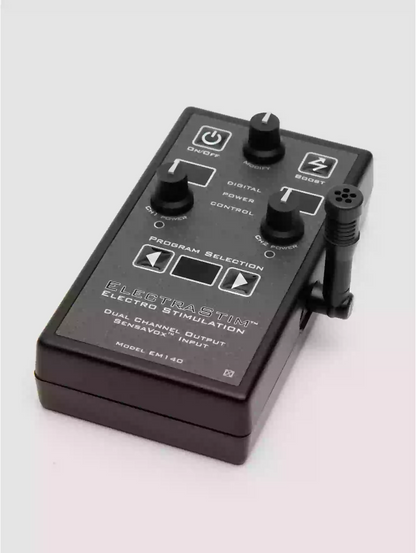 Black electronic device with control knobs on a light gray background