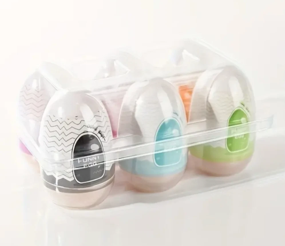 Set of four small containers with colorful lids in a clear plastic case on a white background