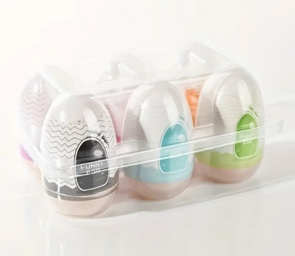 Set of four small containers with colorful lids in a clear plastic case on a white background