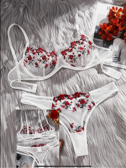 Floral lingerie set on a textured surface with flowers in the background