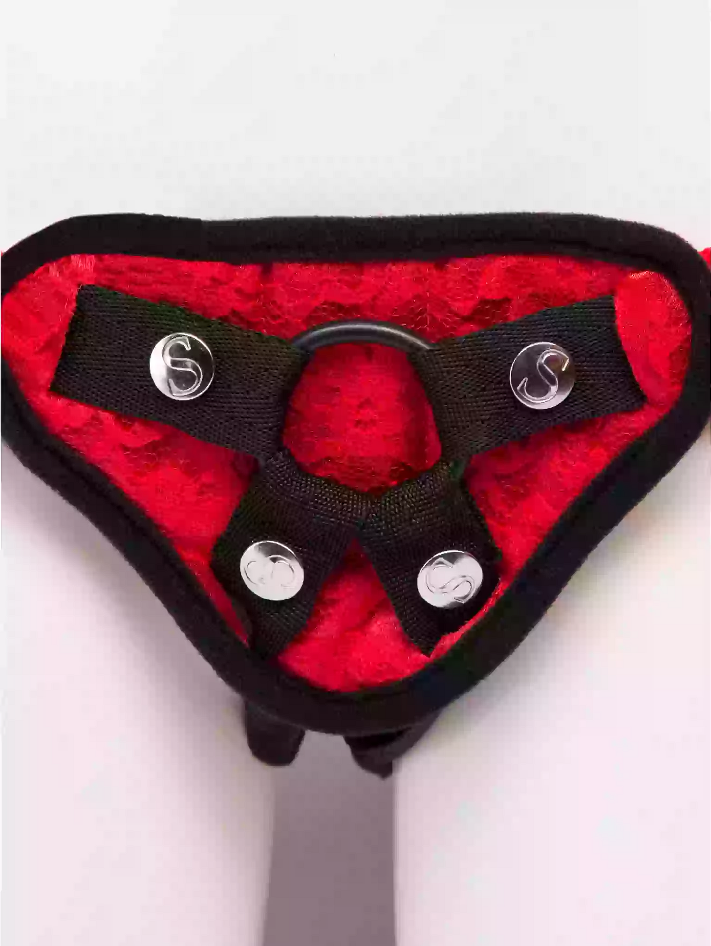 Red and black harness with metal buckles on a white background