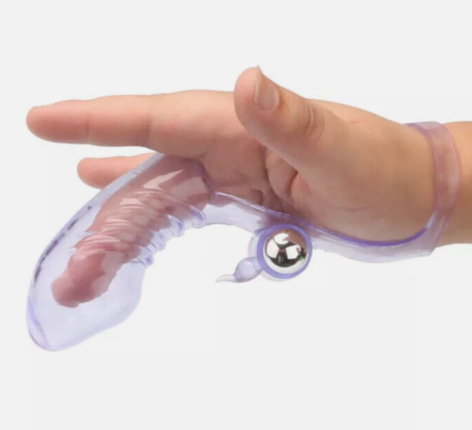Hand using a clear plastic tool with a metallic ball on a white background
