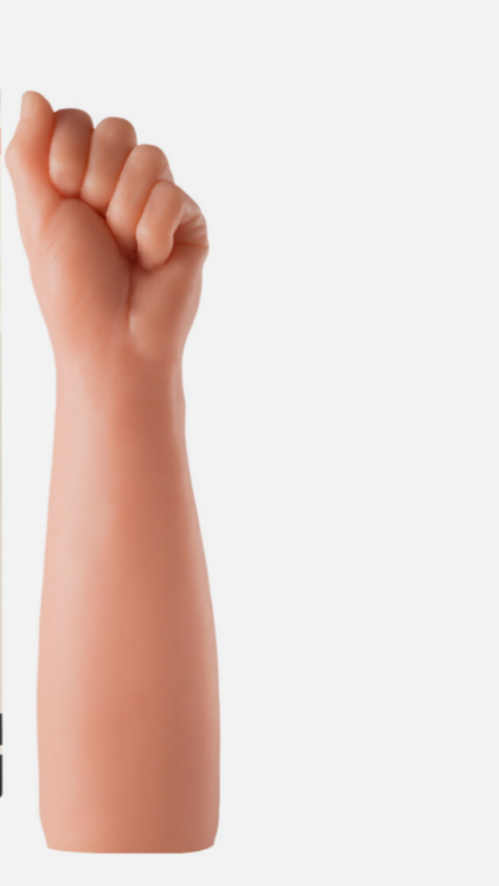 Realistic silicone arm with a clenched fist on a white background