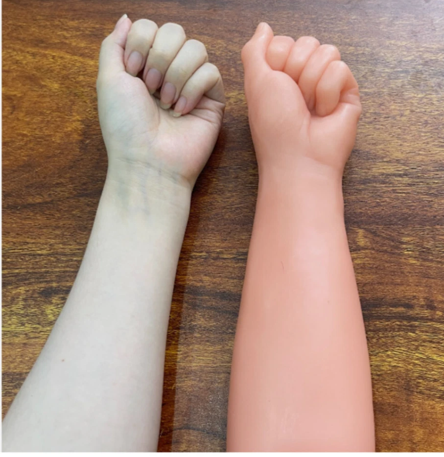 Two fists clenched together on a wooden surface