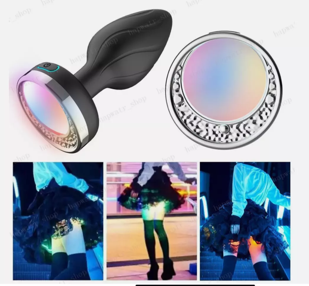 Black electronic device with colorful light display and people wearing LED clothing in the background.