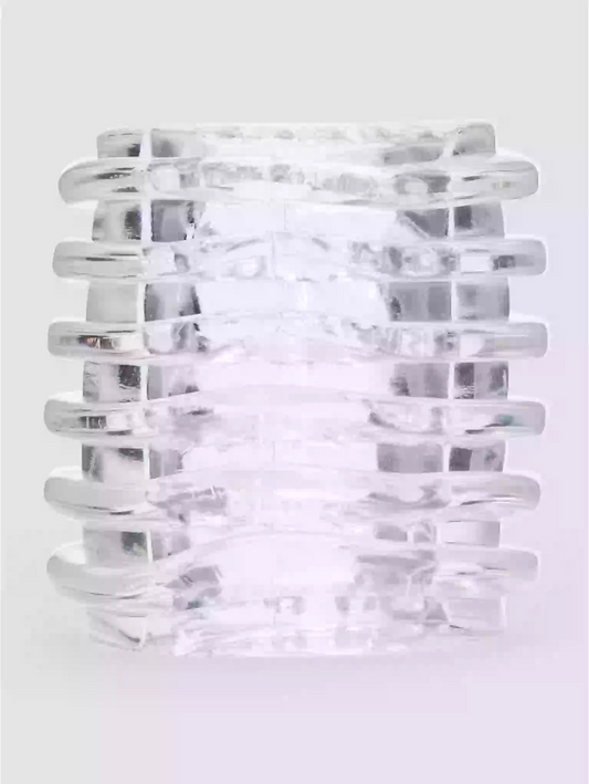 Clear glass candle holder with ribbed design on a white background