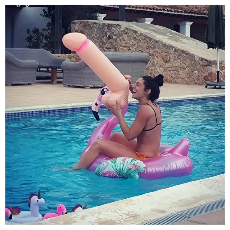 Woman sitting on a pink flamingo pool float in a pool