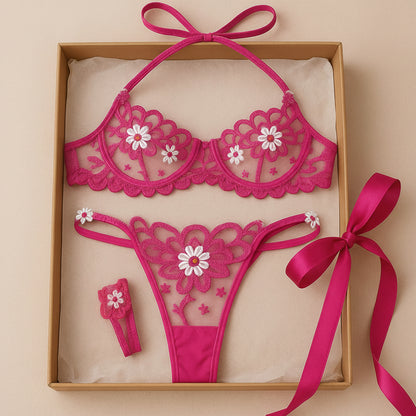 Pink lace lingerie set with floral designs in a box with a pink ribbon.
