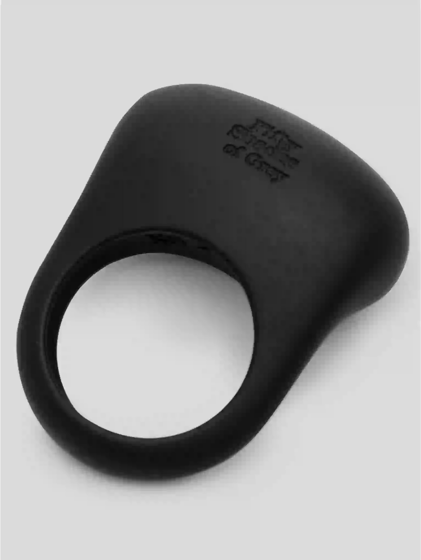 Black silicone ring with brand engraving on a light gray background