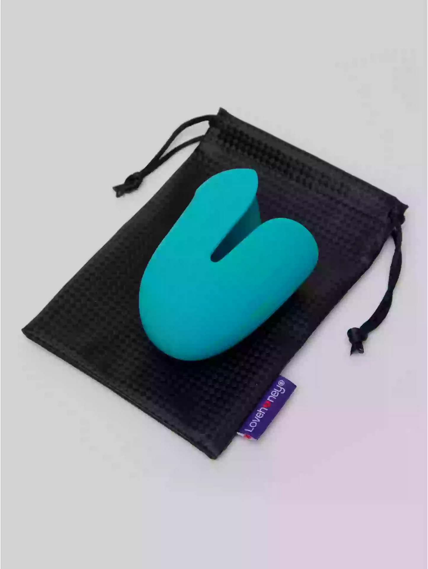 Turquoise stress ball in a black drawstring bag on a light gray background