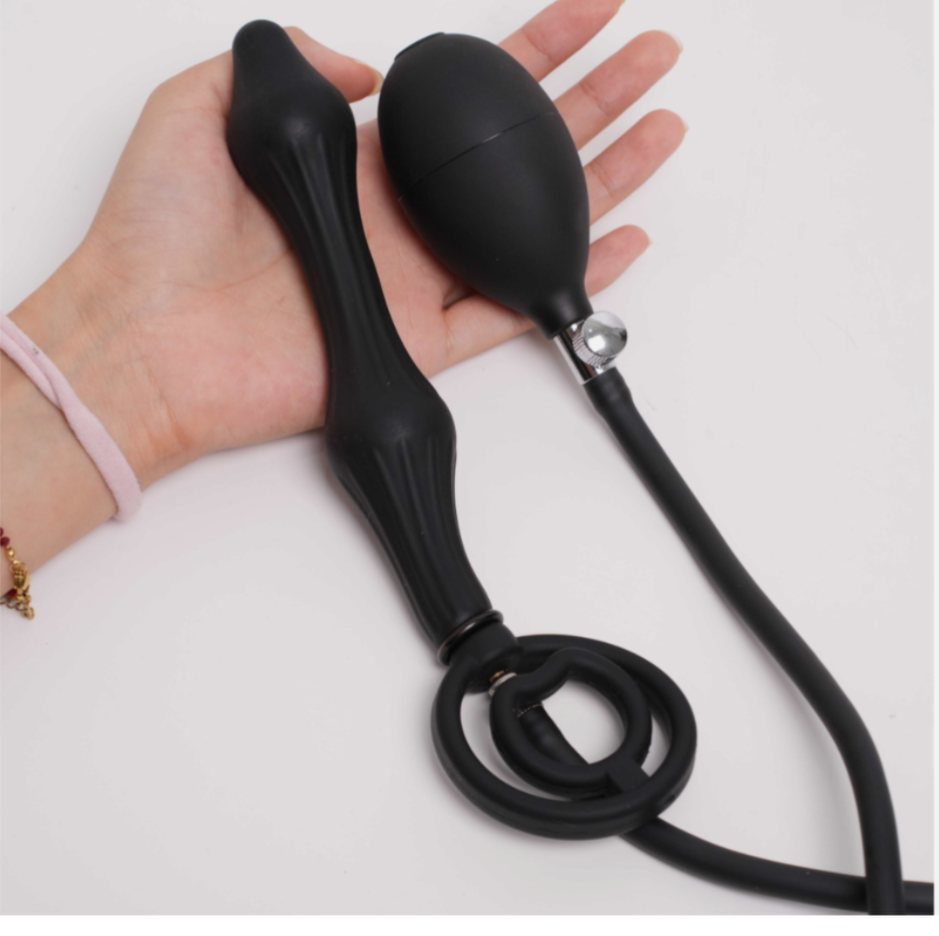 Black bulb pump held in a hand on a white background