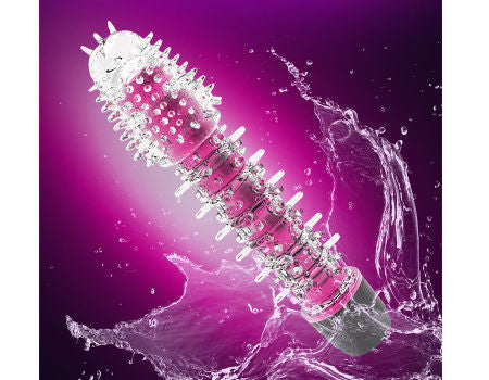 Pink and silver massager with water splash on a purple background