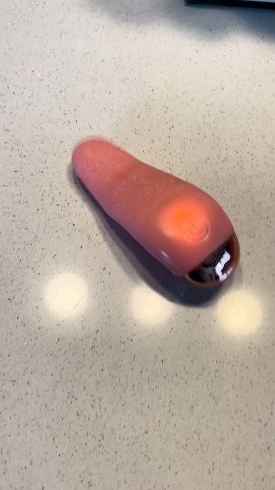 Red electronic device on a speckled countertop