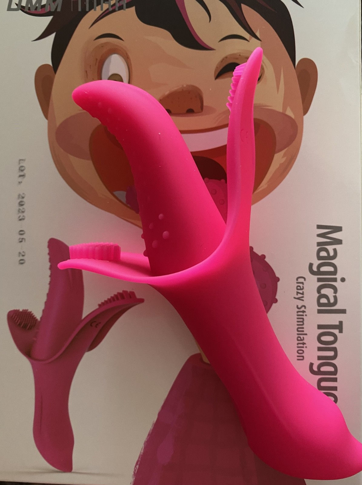 Pink toy resembling a tongue with cartoon character in the background