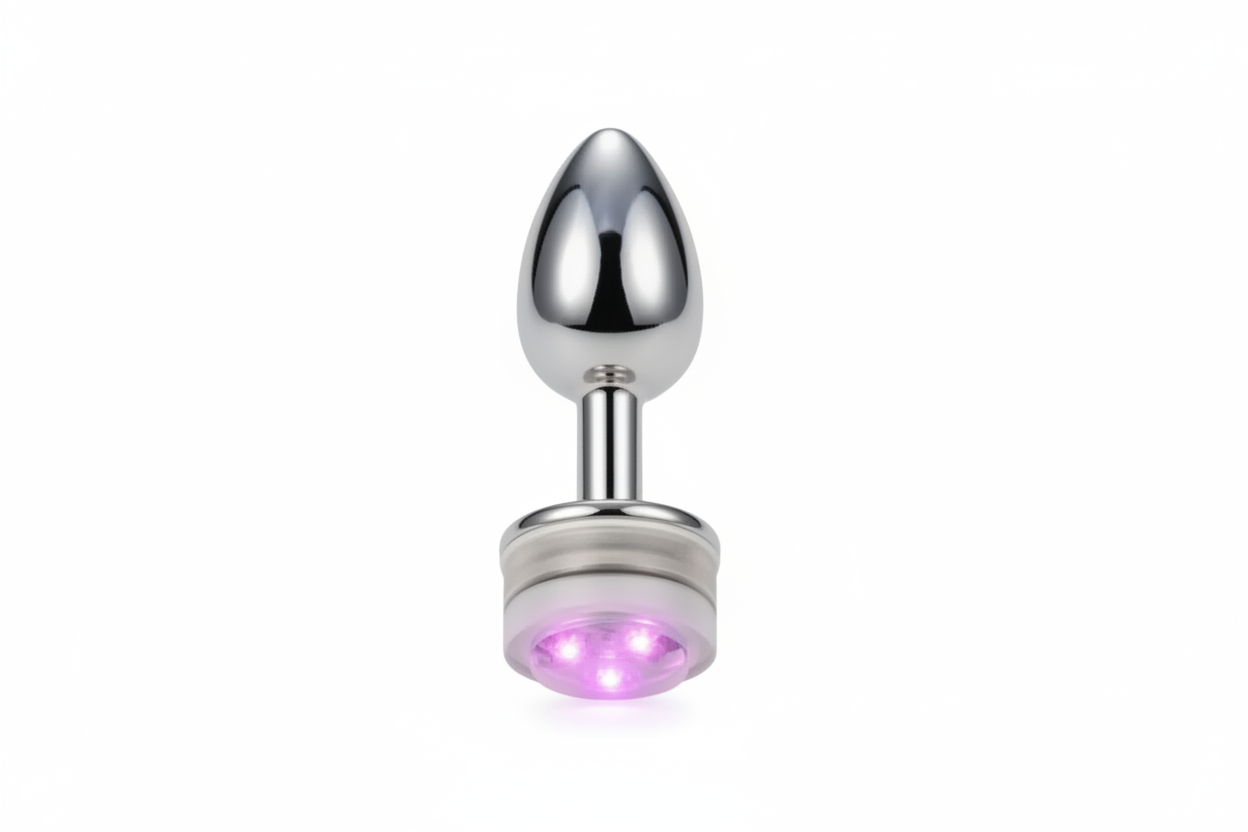 Metallic butt plug with LED light on a white background