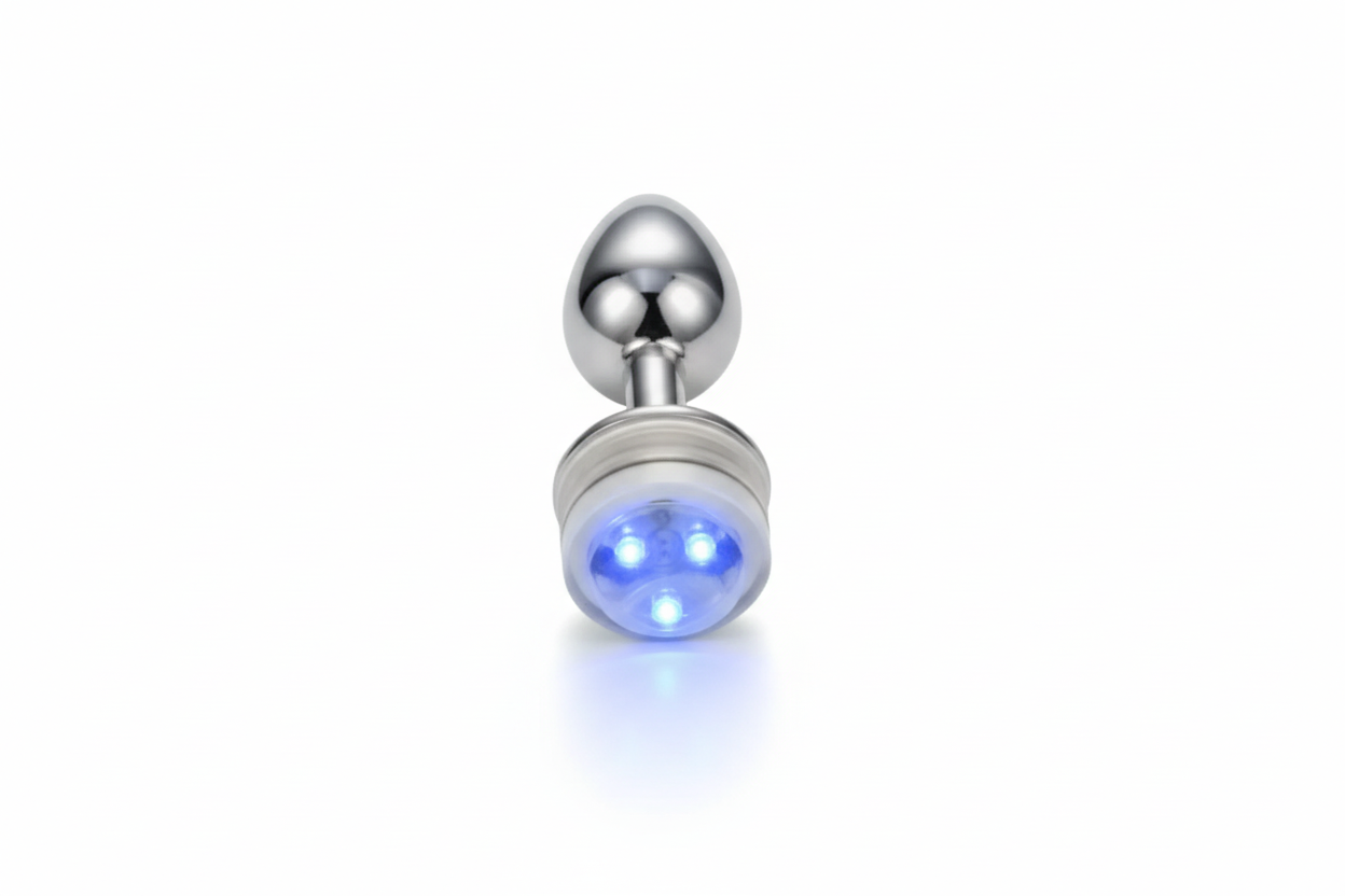 Silver plug with a glowing blue light on a white background