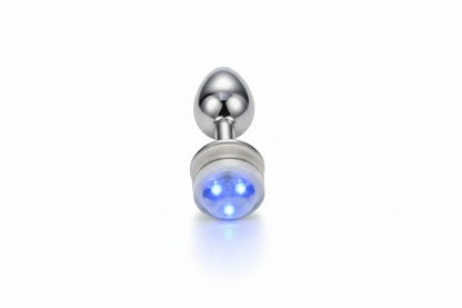 Silver plug with a glowing blue light on a white background