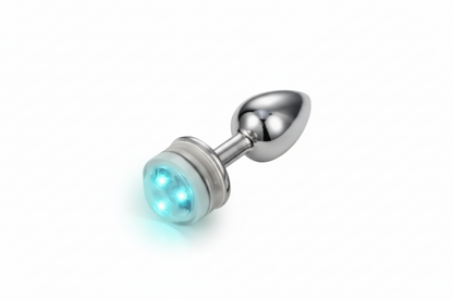 Metallic anal plug with a glowing blue light on a white background