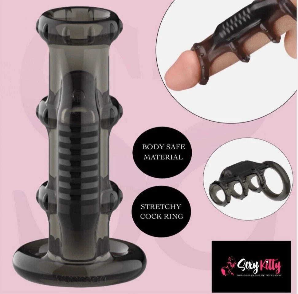 Black stretchy cock ring with 'Body Safe Material' and 'Stretchy Cock Ring' text on a pink background, featuring the brand 'Sassy Kitty'.