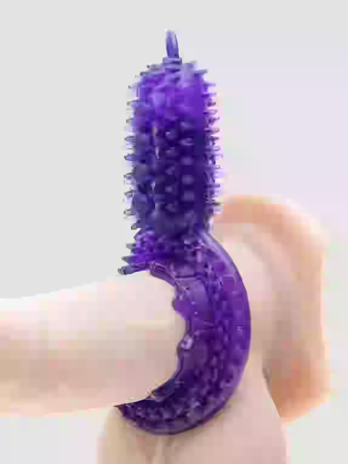 Purple textured device held by a person on a white background