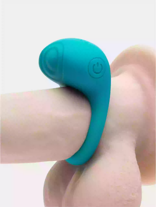 Teal silicone ring on a finger against a light background