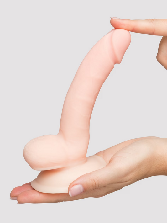 Hand holding a silicone product against a plain background
