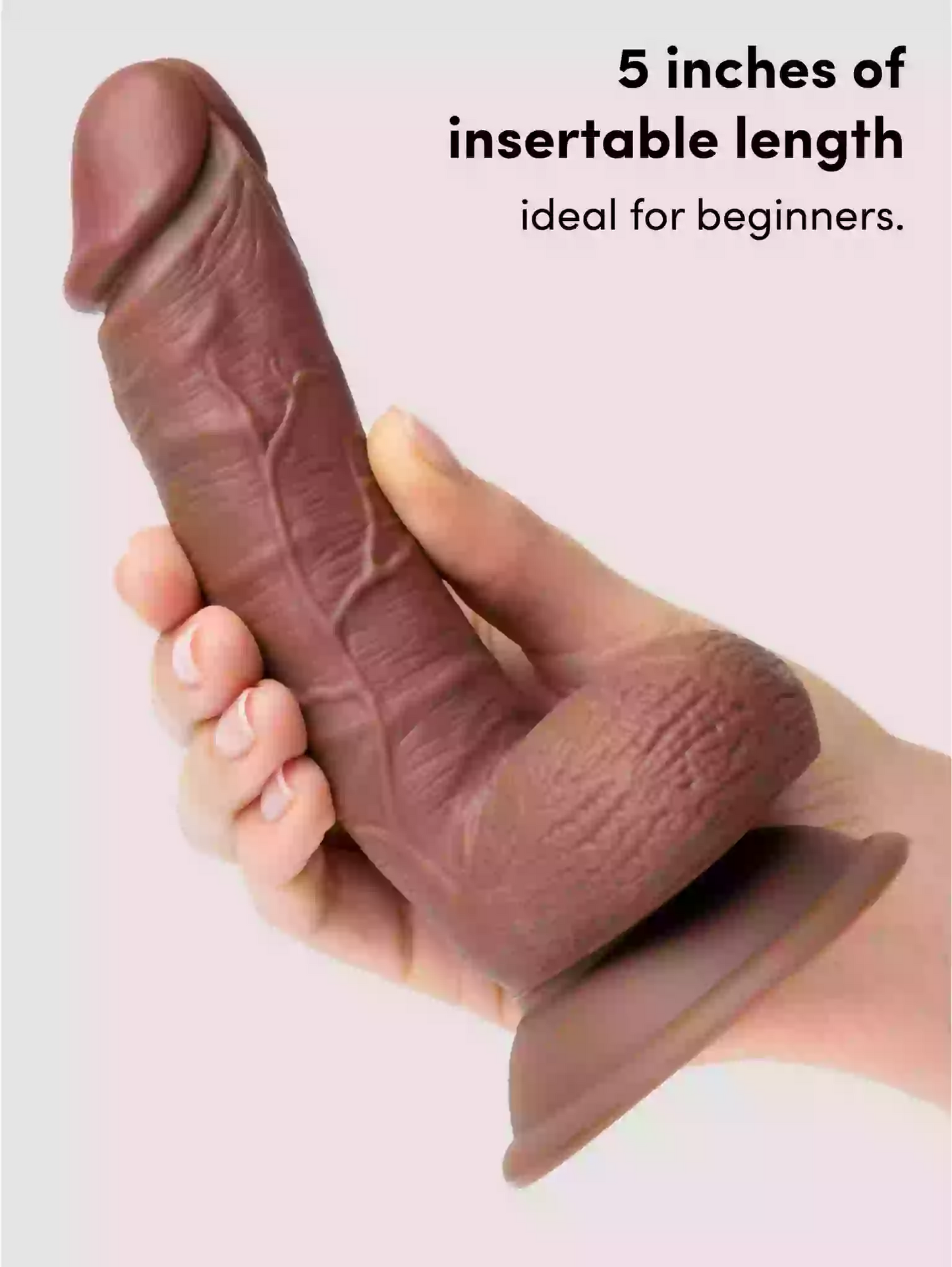 Hand holding a product with text indicating '5 inches of insertable length ideal for beginners' on a light background
